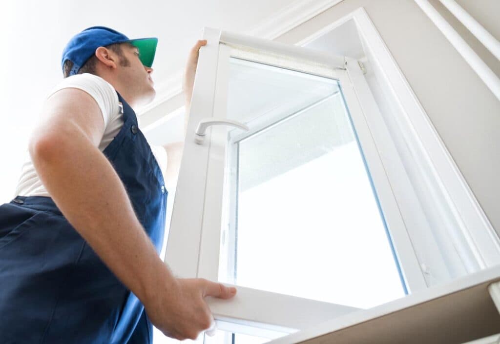 installer installing glass window