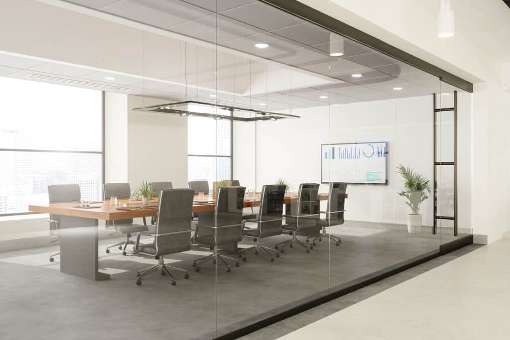 Meeting room with transparent glass walls and a glass door beside a corridor.