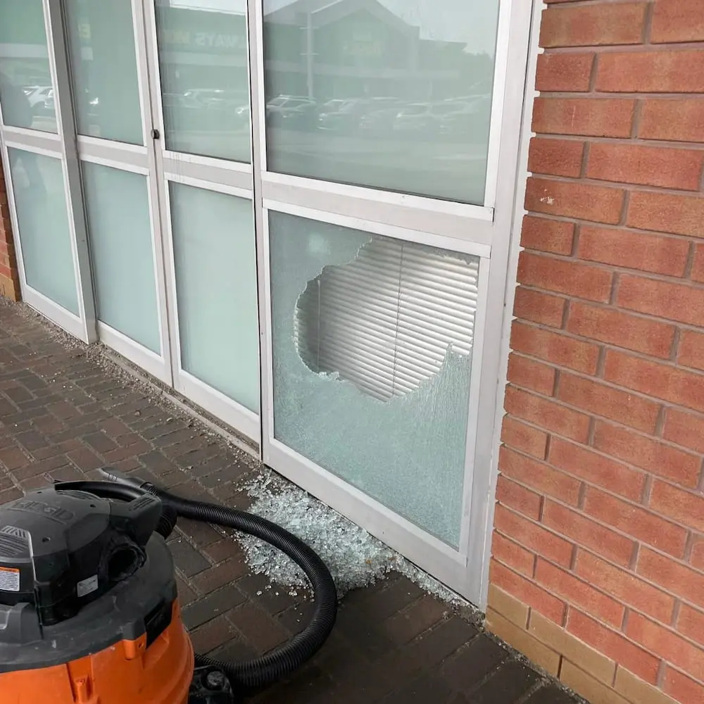 Broken commercial window glass requiring assessment and replacement