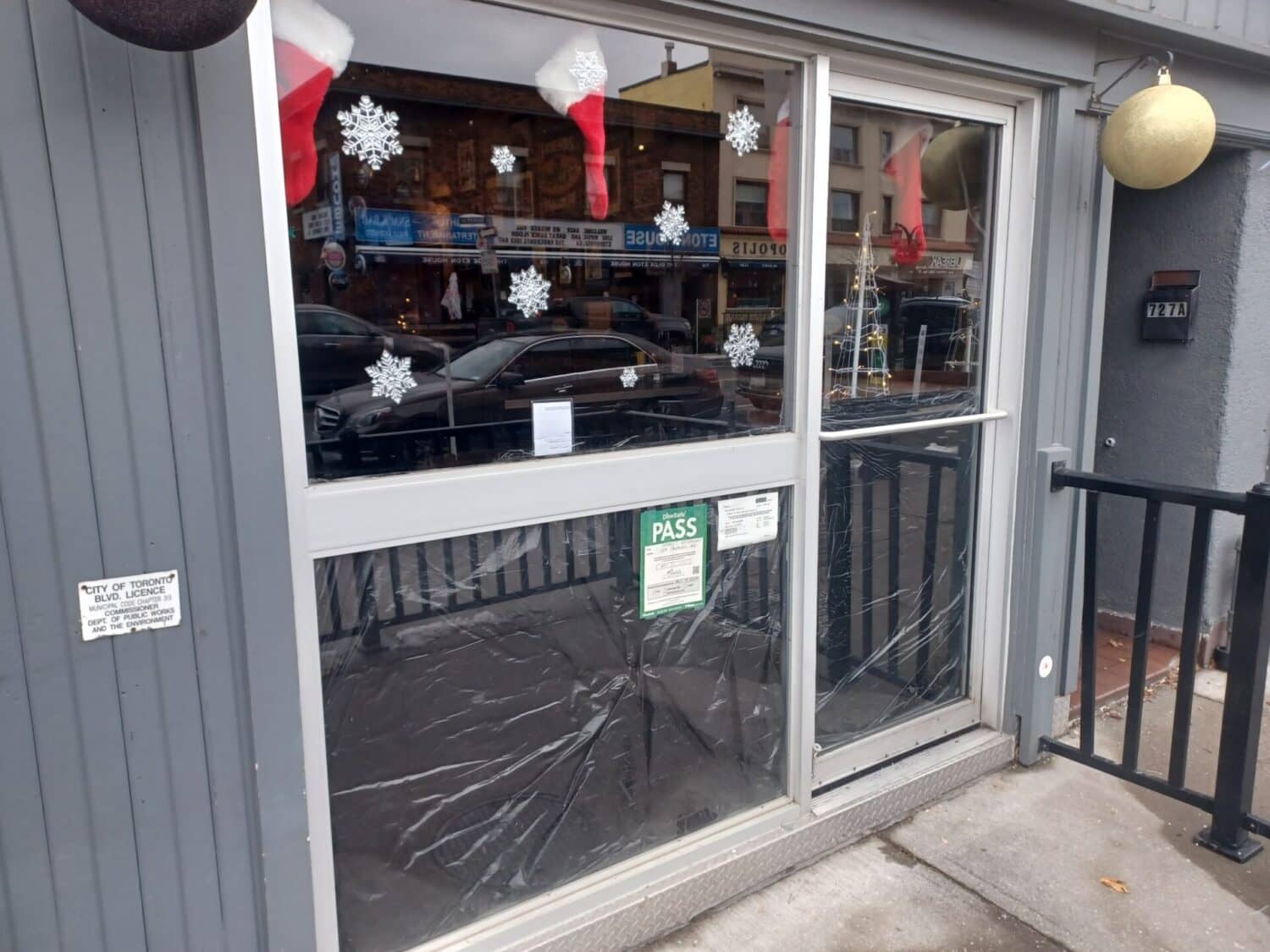 Storefront window and glass door covered with protective film.