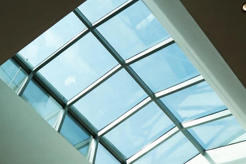 Grid of glass skylight panels viewed from below.