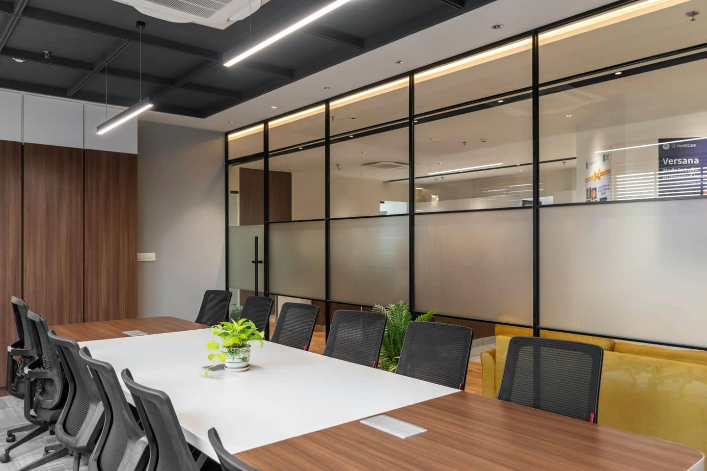 Meeting-room glass partitions with a frosted band across the lower portion.