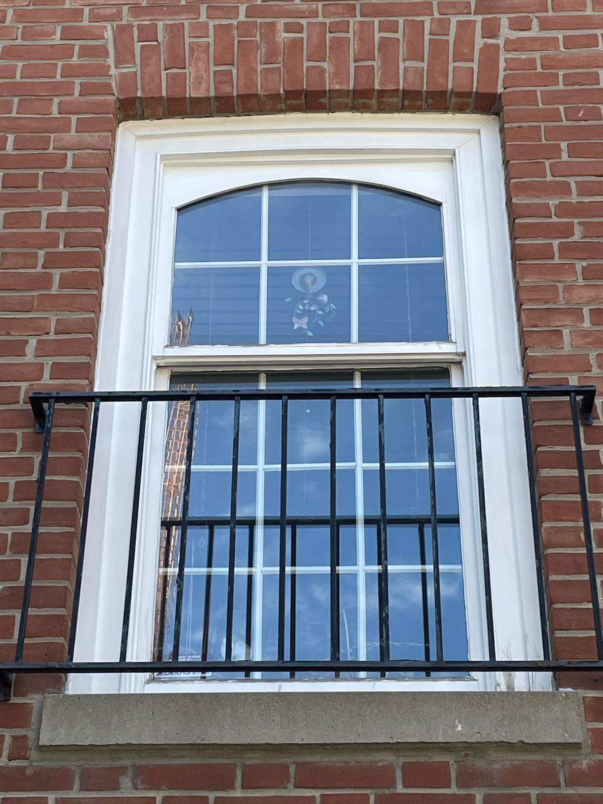 Custom-cut glass window panel prepared for installation