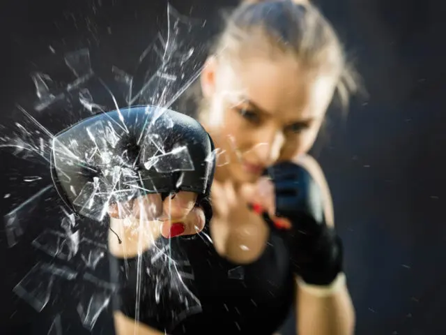 Women Fighter Punching Close Up Glass Shattering