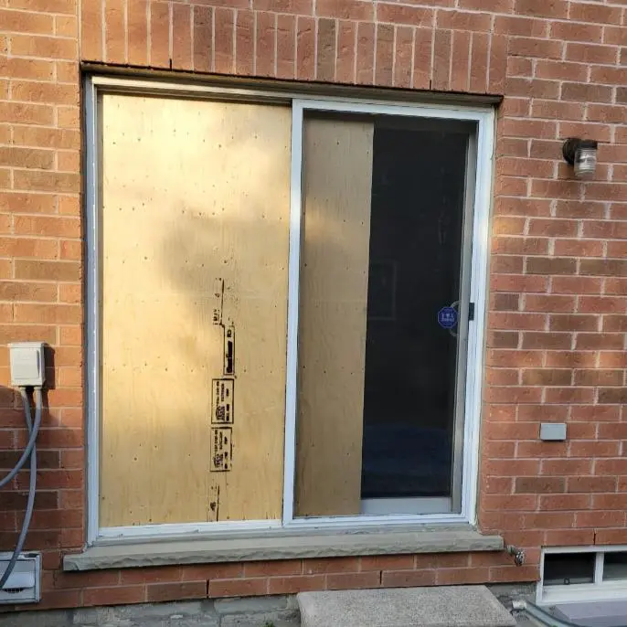 Sliding patio door being assessed for glass and hardware service